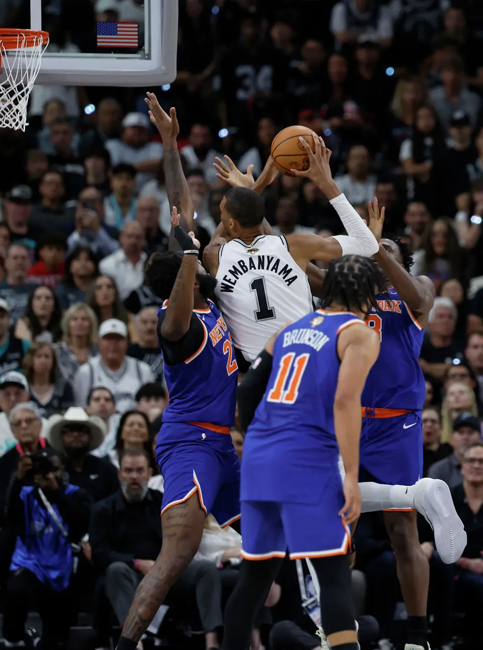 San Antonio Spurs center Victor Wembanyama (1) is surrounded by New York Knicks defenders while trying to take a shot at the basket during the first quarter of Game 2 of the NBA Championship at Frost Bank Center in San Antonio on Friday, June 5, 2026.
