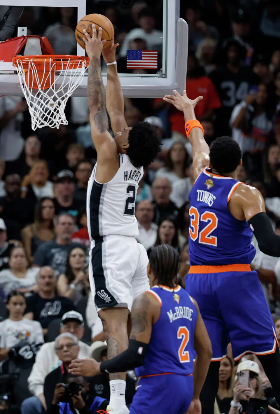 San Antonio Spurs guard Dylan Harper (2) dunks the ball while New York Knicks center Karl-Anthony Towns (32) tries to block him during the first quarter of Game 2 of the NBA Championship at Frost Bank Center in San Antonio on Friday, June 5, 2026.