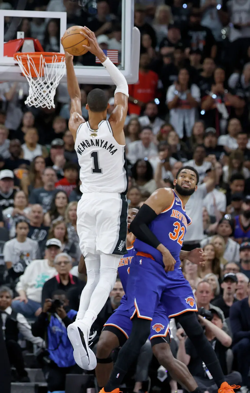 San Antonio Spurs center Victor Wembanyama (1) goes for the dunk over the top of New York Knicks center Karl-Anthony Towns (32) during the first quarter of Game 2 of the NBA Championship at Frost Bank Center in San Antonio on Friday, June 5, 2026.