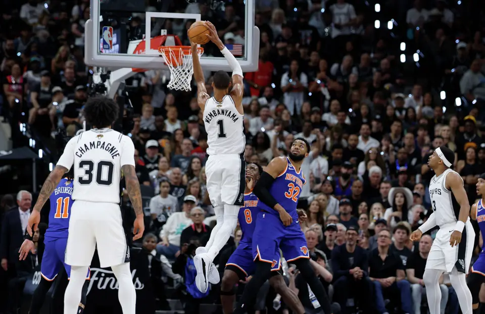 San Antonio Spurs center Victor Wembanyama (1) goes for the dunk over the top of New York Knicks center Karl-Anthony Towns (32) during the first quarter of Game 2 of the NBA Championship at Frost Bank Center in San Antonio on Friday, June 5, 2026.