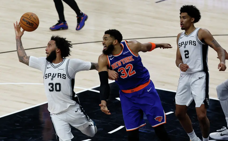 San Antonio Spurs forward Julian Champagnie (30)grabs a rebound over New York Knicks center Karl-Anthony Towns (32) during the second quarter of Game 2 of the NBA Championship at Frost Bank Center in San Antonio on Friday, June 5, 2026.