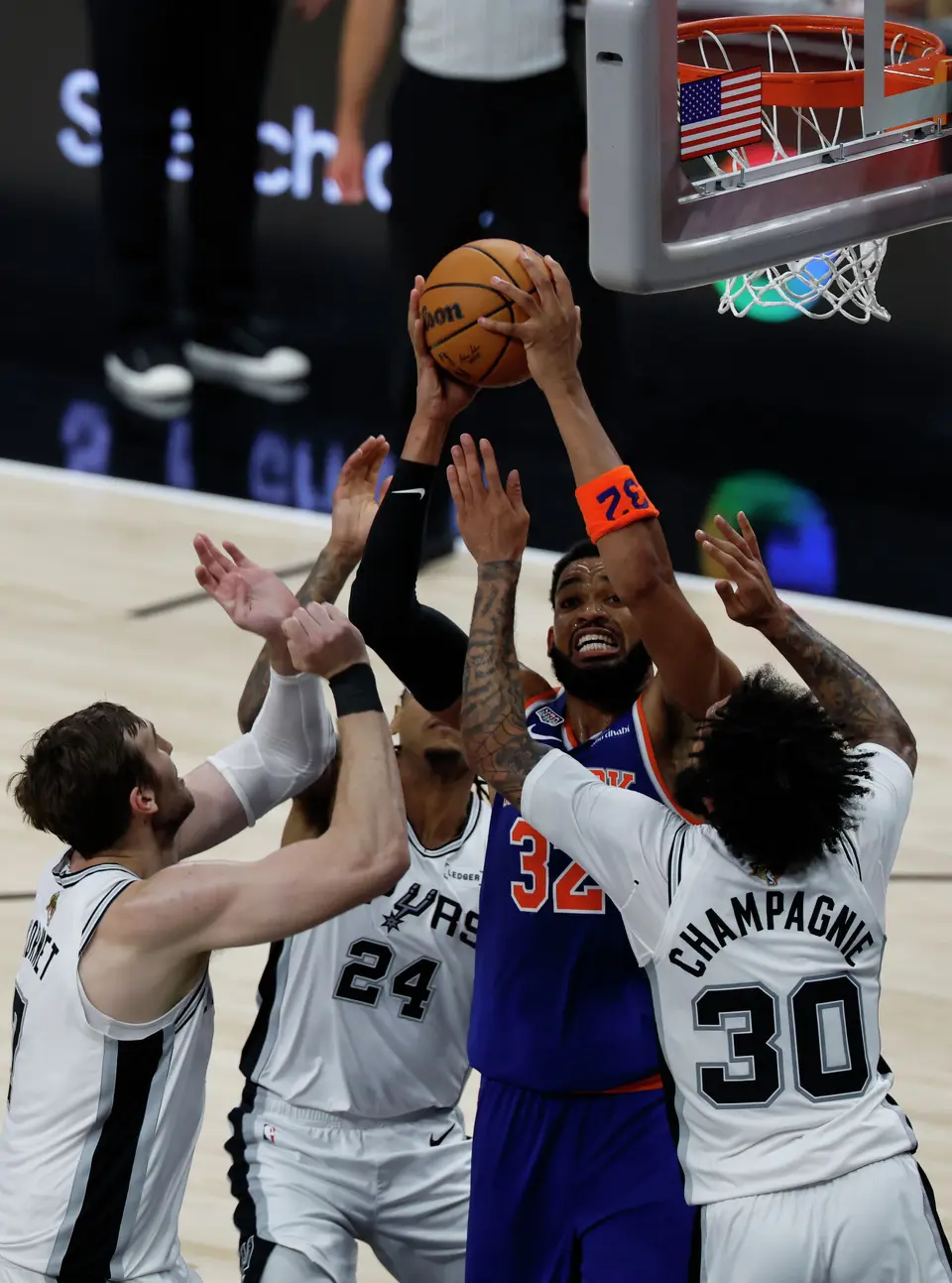 New York Knicks center Karl-Anthony Towns (32) tries to make a basket while surrounded by Spurs players during the second quarter of Game 2 of the NBA Championship at Frost Bank Center in San Antonio on Friday, June 5, 2026.