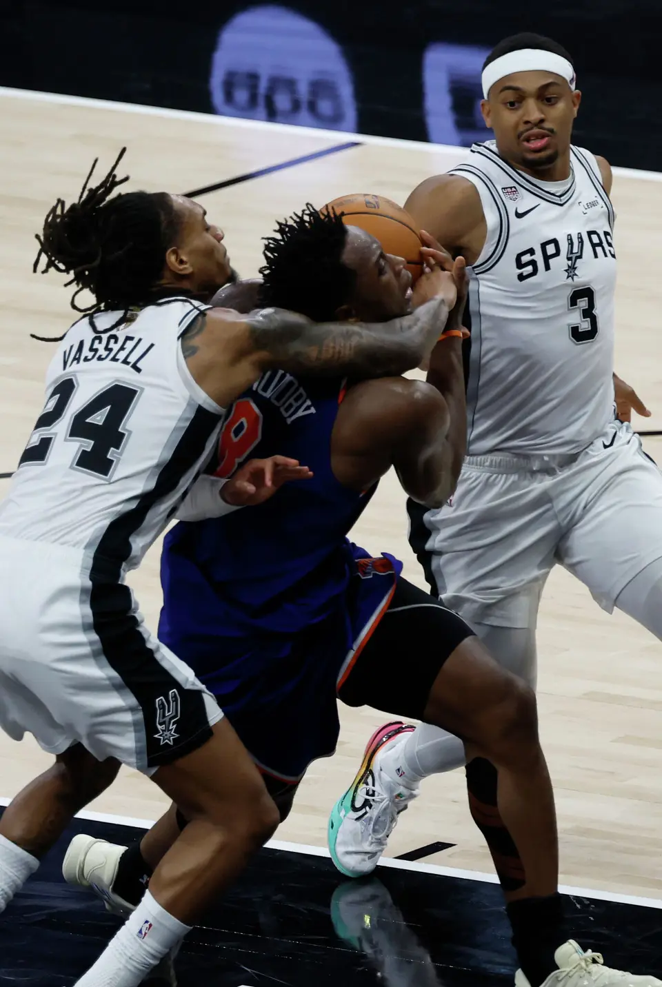 San Antonio Spurs guard Devin Vassell (24) and San Antonio Spurs forward Keldon Johnson (3) block New York Knicks forward Og Anunoby (8) during the second quarter of Game 2 of the NBA Championship at Frost Bank Center in San Antonio on Friday, June 5, 2026.