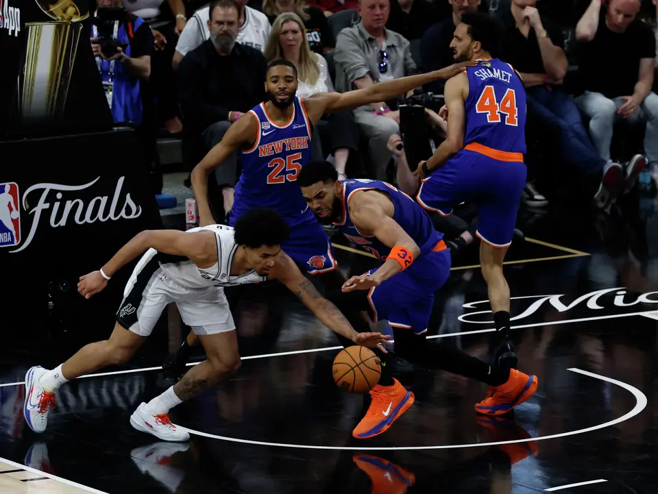 San Antonio Spurs guard Dylan Harper (2) and New York Knicks center Karl-Anthony Towns (32) fight for a loose ball during the second quarter of Game 2 of the NBA Championship at Frost Bank Center in San Antonio on Friday, June 5, 2026.