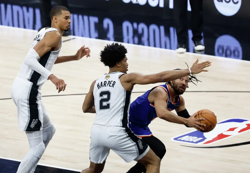 New York Knicks guard Jalen Brunson (11) looks for an open shot past San Antonio Spurs guard Dylan Harper (2) during the second quarter of Game 2 of the NBA Championship at Frost Bank Center in San Antonio on Friday, June 5, 2026.