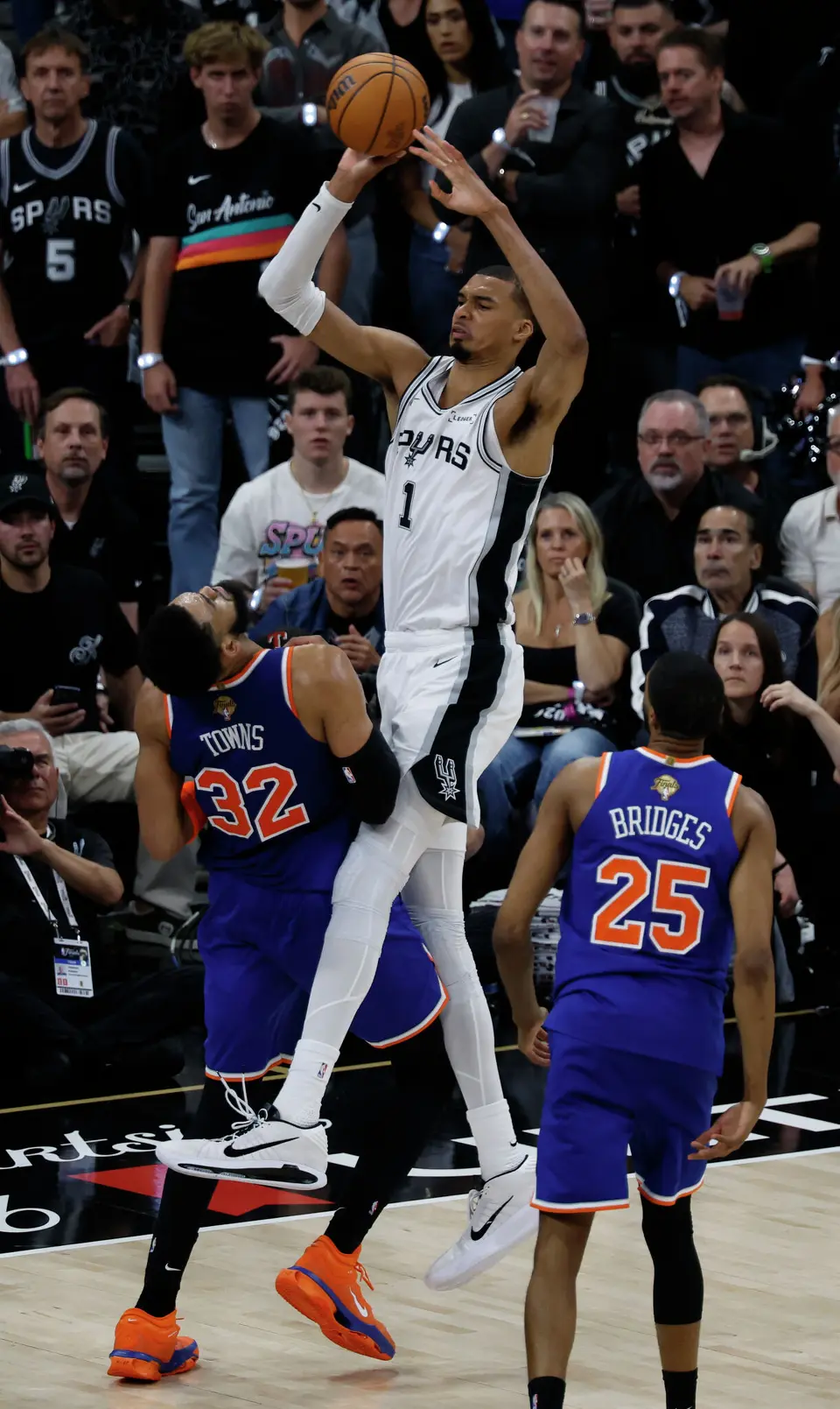 San Antonio Spurs center Victor Wembanyama (1) makes a shot over New York Knicks center Karl-Anthony Towns (32) during the second quarter of Game 2 of the NBA Championship at Frost Bank Center in San Antonio on Friday, June 5, 2026.