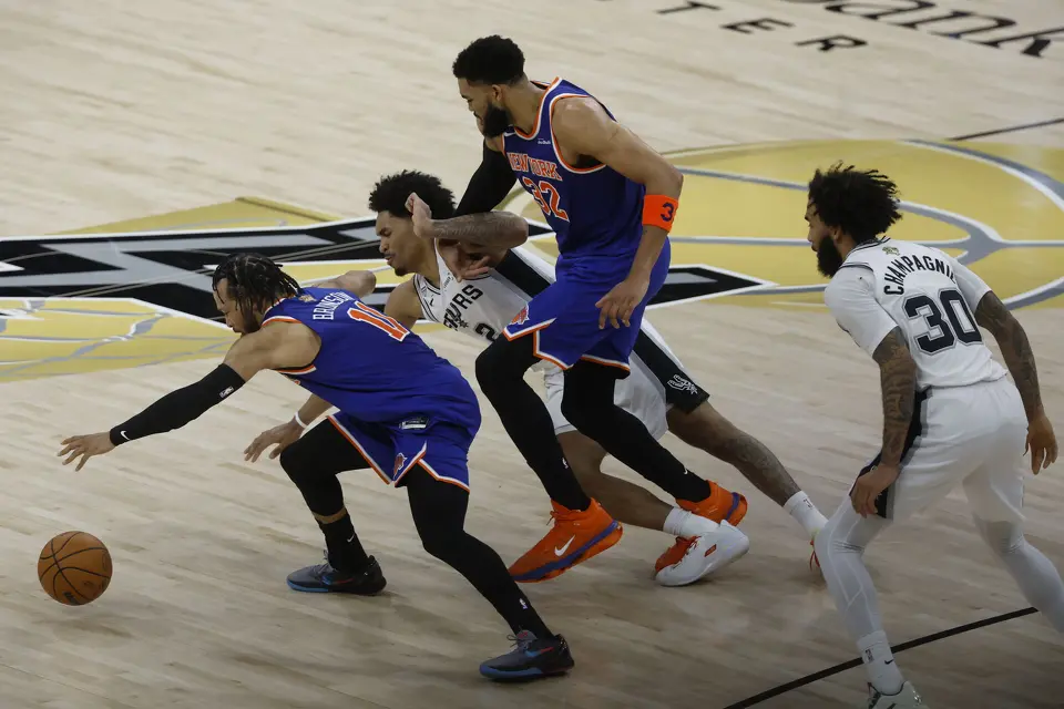 New York Knicks guard Jalen Brunson (11), San Antonio Spurs guard Dylan Harper (2) and New York Knicks center Karl-Anthony Towns (32) scramble to gain possession of a loose ball during the second quarter of Game 2 of the NBA Championship at Frost Bank Center in San Antonio on Friday, June 5, 2026.