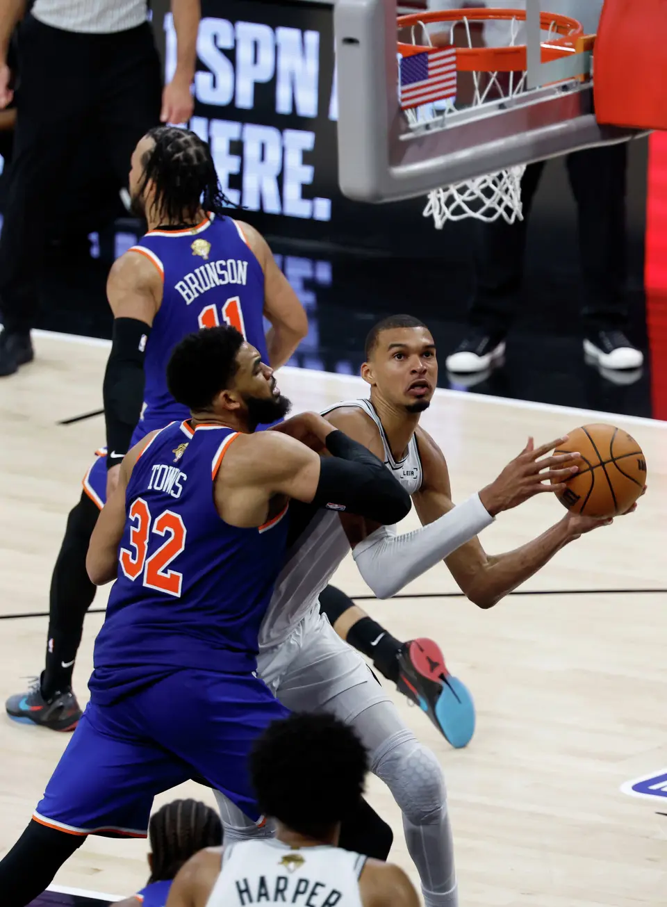 San Antonio Spurs center Victor Wembanyama (1) looks for a clean shot at the basket while being guarded by New York Knicks center Karl-Anthony Towns (32) during the fourth quarter of Game 2 of the NBA Championship at Frost Bank Center in San Antonio on Friday, June 5, 2026. The Knicks beat the Spurs 105 to 104 to take a 2-0 lead.