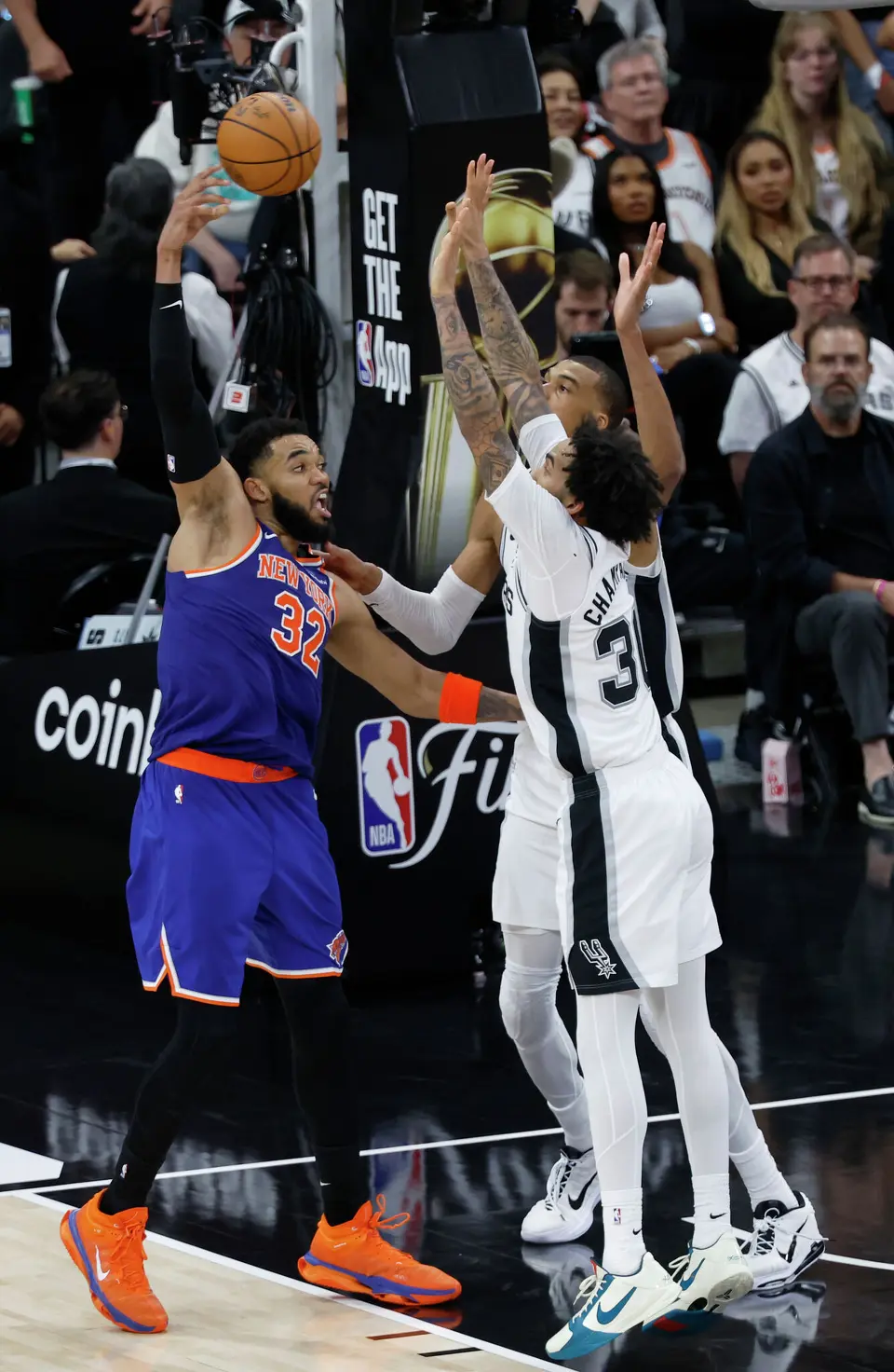 New York Knicks center Karl-Anthony Towns (32) loops the ball over San Antonio Spurs forward Julian Champagnie (30) and San Antonio Spurs center Victor Wembanyama (1) during the fourth quarter of Game 2 of the NBA Championship at Frost Bank Center in San Antonio on Friday, June 5, 2026. The Knicks beat the Spurs 105 to 104 to take a 2-0 lead.