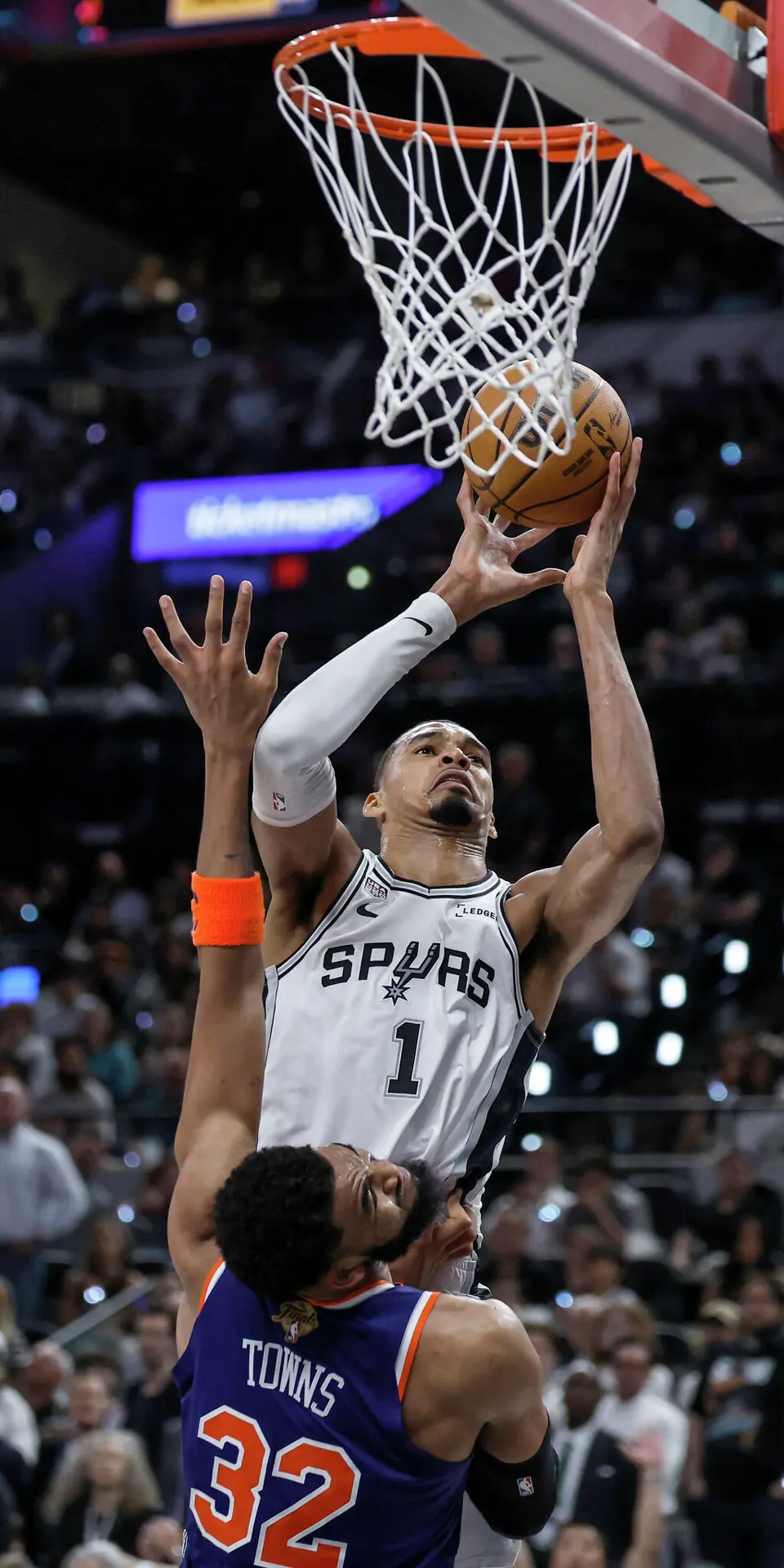 San Antonio Spurs center Victor Wembanyama (1) drives to the basket at the expense of New York Knicks center Karl-Anthony Towns (32) during the third quarter of Game 2 of the NBA Championship at Frost Bank Center in San Antonio on Friday, June 5, 2026.