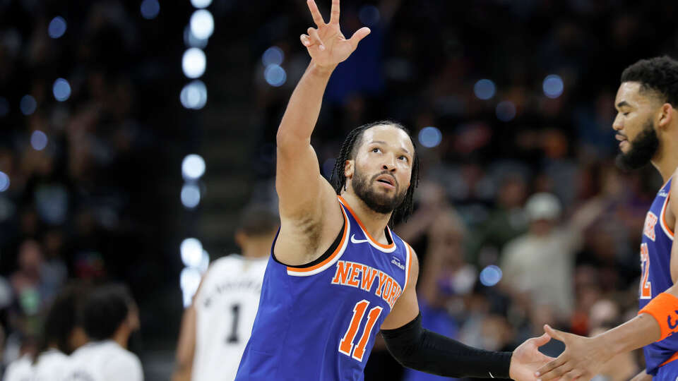 New York Knicks guard Jalen Brunson (11) shows some love towards fans after scoring a three point shot during the third quarter of Game 2 of the NBA Championship at Frost Bank Center in San Antonio on Friday, June 5, 2026.