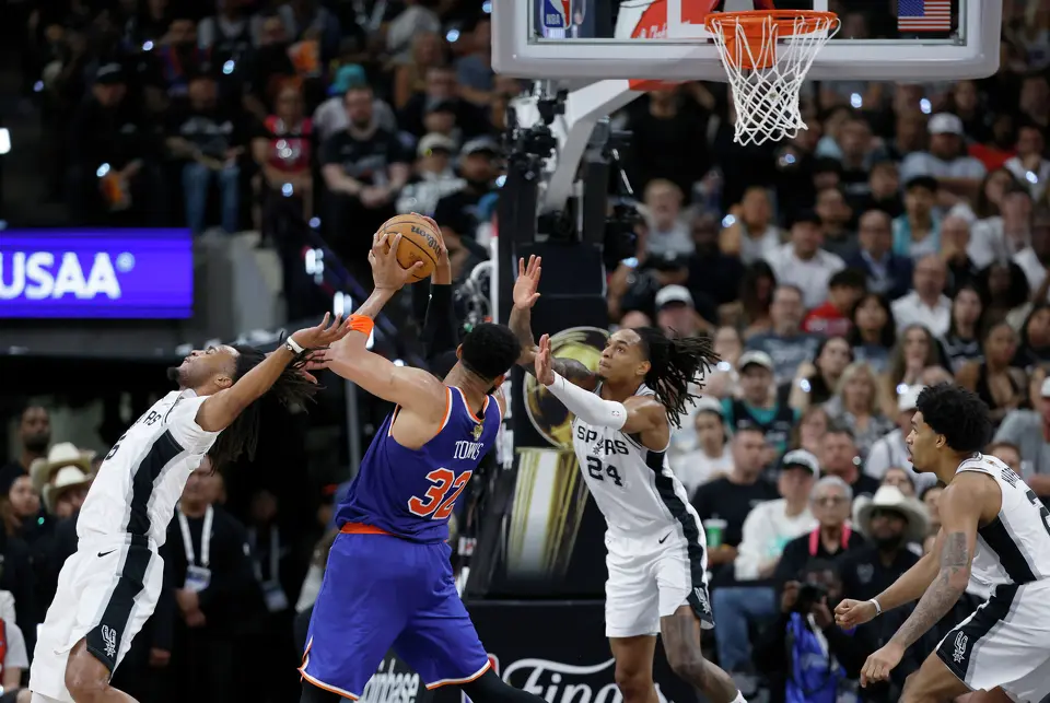 New York Knicks center Karl-Anthony Towns (32) grabs a rebound from San Antonio Spurs guard Stephon Castle (5) and San Antonio Spurs guard Devin Vassell (24) during the third quarter of Game 2 of the NBA Championship at Frost Bank Center in San Antonio on Friday, June 5, 2026.