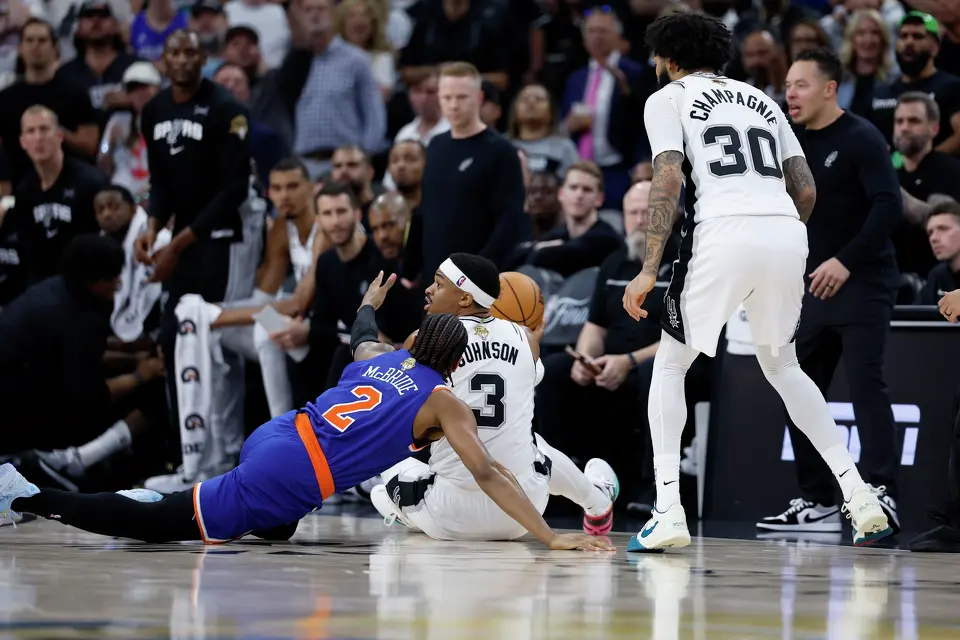 San Antonio Spurs forward Keldon Johnson (3) grabs a loose ball away from New York Knicks guard Miles McBride (2) during the third quarter of Game 2 of the NBA Championship at Frost Bank Center in San Antonio on Friday, June 5, 2026.