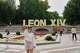 Visitors pose for photos beside a sign bearing the name of Pope Leo XIV in Madrid, Spain, Saturday, June 6, 2026.