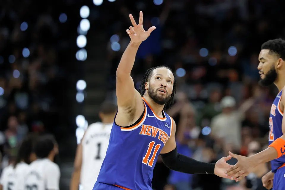 New York Knicks guard Jalen Brunson (11) shows some love towards fans after scoring a three point shot during the third quarter of Game 2 of the NBA Championship at Frost Bank Center in San Antonio on Friday, June 5, 2026.