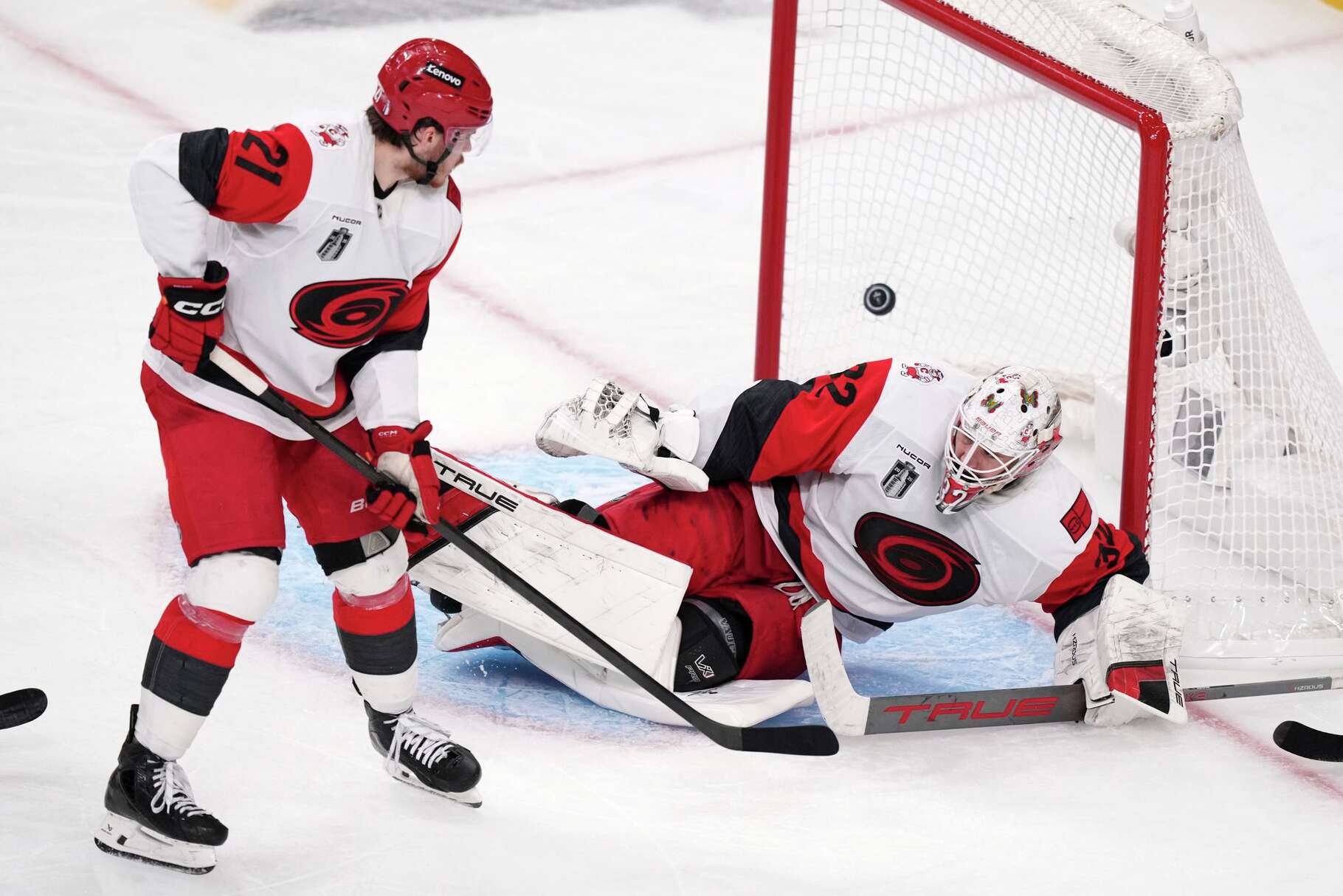 Carolina Hurricanes goaltender Brandon Bussi, right, is scored on by Carolina Hurricanes left wing Nikolaj Ehlers as defenseman Alexander Nikishin watches during the second overtime in Game 3 of the NHL hockey Stanley Cup Final series Saturday, June 6, 2026, in Las Vegas.