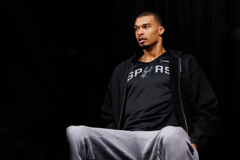 San Antonio Spurs center Victor Wembanyama listens to head coach Mitch Johnson’s news conference as he waits for his turn at the microphone during a news conference at Madison Square Garden in New York, Sunday, June 7, 2026, ahead of Game 3 of the NBA Finals against the New York Knicks.