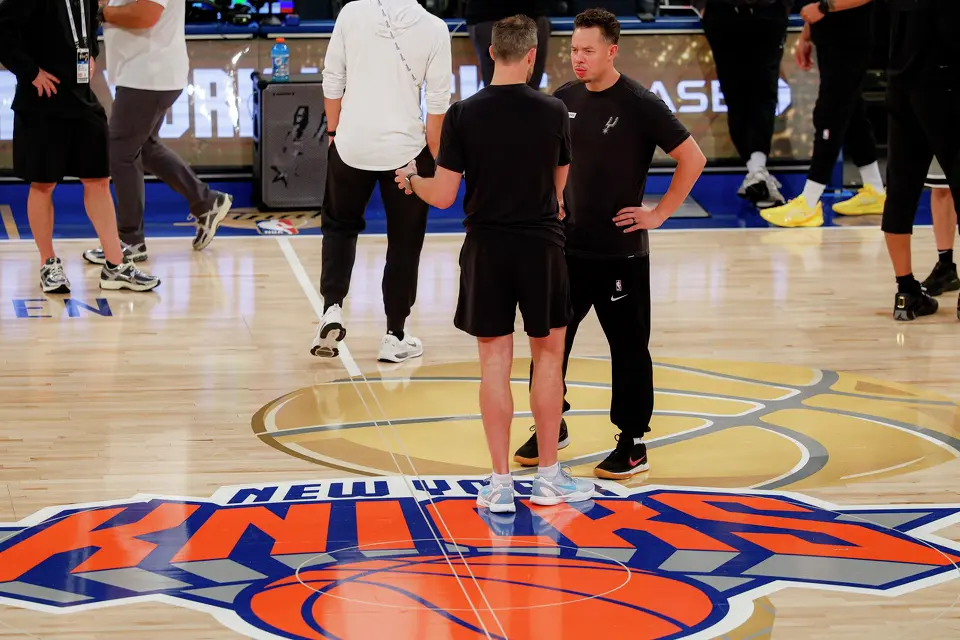 San Antonio Spurs head coach Mitch Johnson, right, talks to a member of his coaching staff as they stand on the NBA Finals court logo during practice at Madison Square Garden in New York, Sunday, June 7, 2026, ahead of Game 3 of the NBA Finals against the New York Knicks.