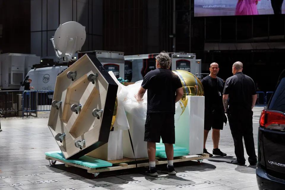 Workers prepare to wheel a large replica of the Larry O'Brien Championship Trophy inside Madison Square Garden in New York, Monday, June 8, 2026, ahead of Game 3 of the NBA Finals between the San Antonio Spurs and the New York Knicks.