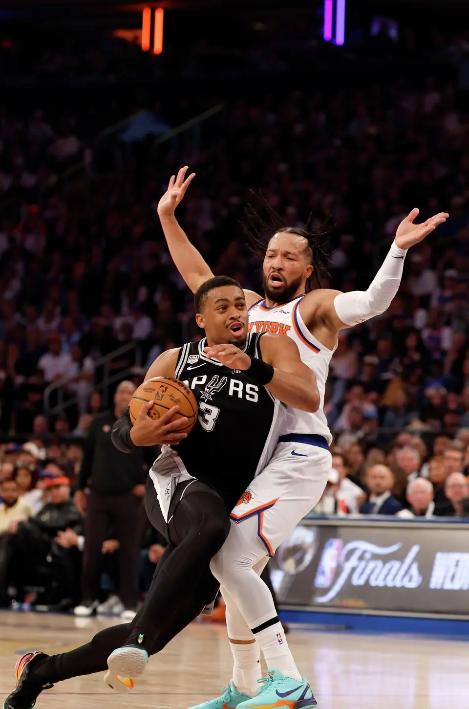 San Antonio Spurs forward Keldon Johnson (3) breaks past New York Knicks guard Jalen Brunson (11) to score during the first half of game three of the NBA Championship at Madison Square Garden in New York City on Monday, June 8, 2026.