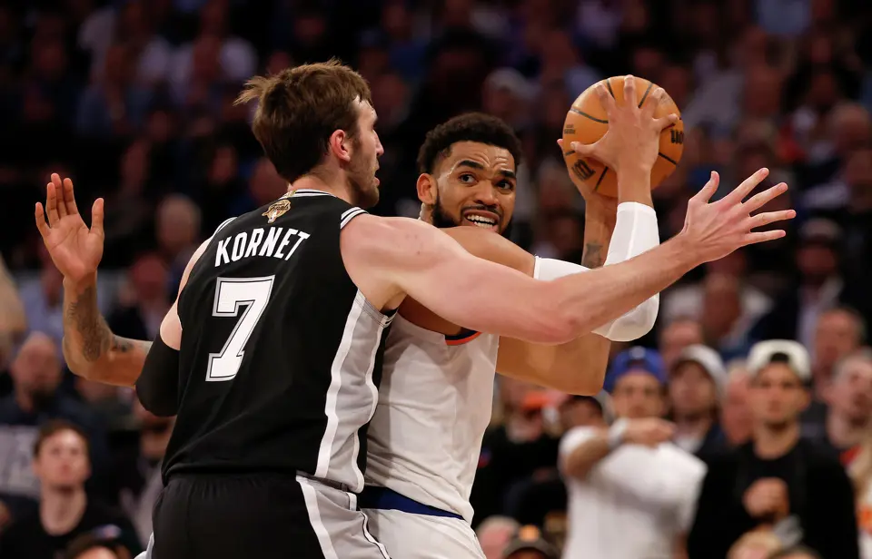 New York Knicks center Karl-Anthony Towns (32) looks to pass while being defended by San Antonio Spurs center Luke Kornet (7) during the third quarter of Game 3 of the NBA Finals at Madison Square Garden in New York, Monday, June 8, 2026.