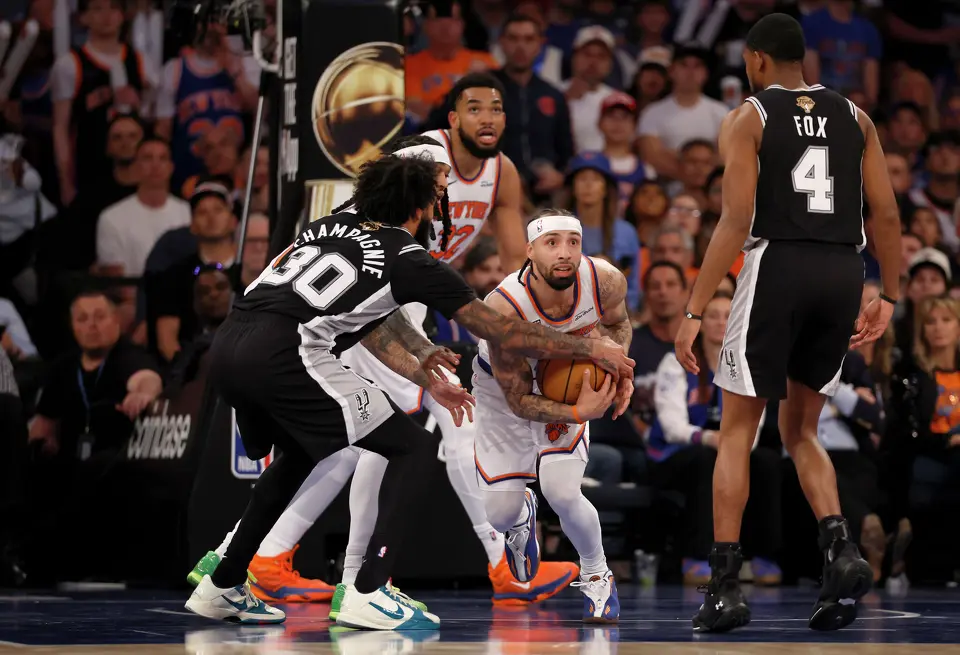 New York Knicks guard Jose Alvarado (5) grabs the rebound away from San Antonio Spurs forward Julian Champagnie (30) during the third quarter of Game 3 of the NBA Finals at Madison Square Garden in New York, Monday, June 8, 2026.