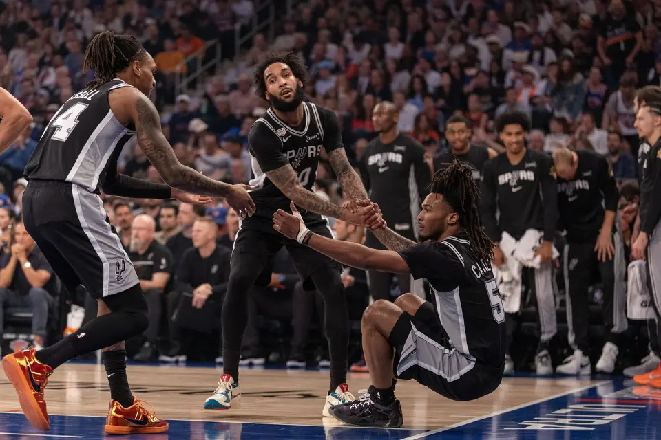 San Antonio Spurs guard Stephon Castle (5) is helped up after being fouled by teammates San Antonio Spurs forward Julian Champagnie (30) and San Antonio Spurs guard Devin Vassell (24) during the first half of game three of the NBA Championship at Madison Square Garden in New York City on Monday, June 8, 2026.