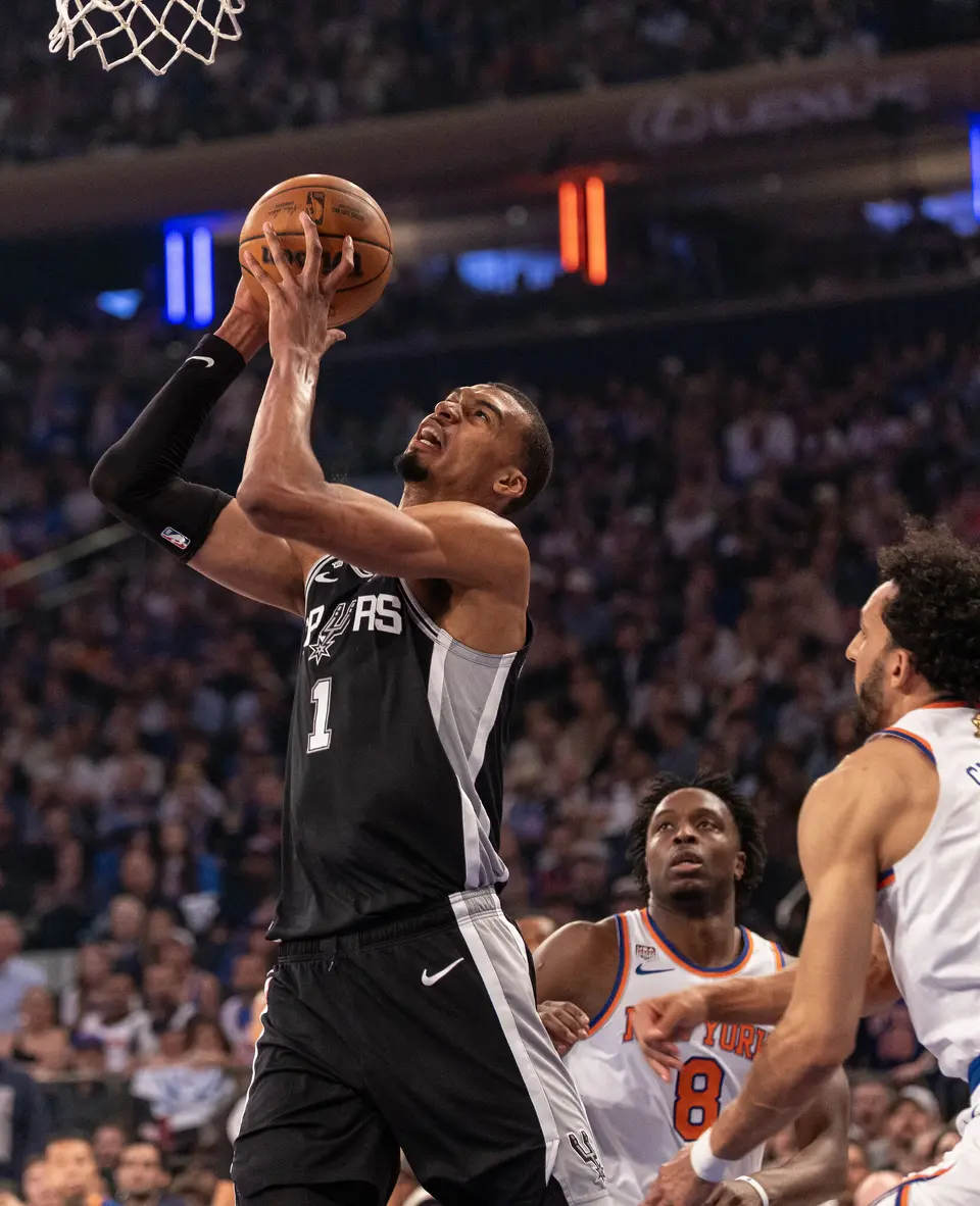 San Antonio Spurs center Victor Wembanyama (1) gets a basket as New York Knicks forward Og Anunoby (8) and New York Knicks guard Landry Shamet (44) watch during the first half of game three of the NBA Championship at Madison Square Garden in New York City on Monday, June 8, 2026.