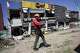 A rescuer walks past a damaged building following an earhtquake in General Santos, Philippines Tuesday, June 9, 2026.