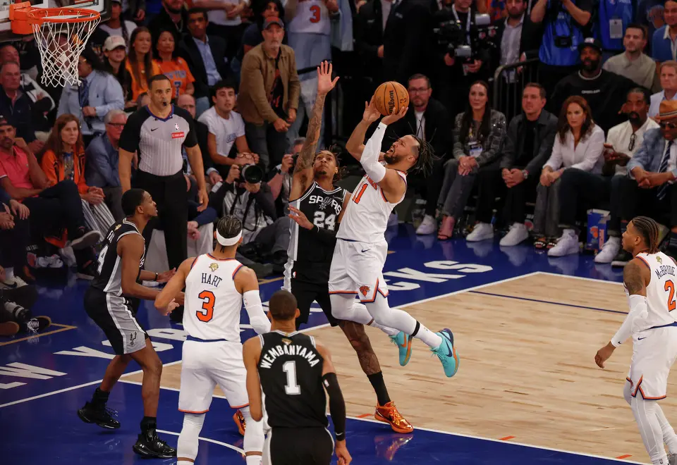 New York Knicks guard Jalen Brunson (11) takes a jump shot over San Antonio Spurs guard Devin Vassell (24) during the fourth quarter of Game 3 of the NBA Finals at Madison Square Garden in New York, Monday, June 8, 2026. The Spurs defeated the Knicks 115-111.