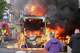 People watch as firemen arrive to put out vehicle that was set alight during a protest in East Belfast following a stabbing incident in Belfast, Tuesday, June 9, 2026.