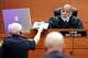 The bailiff hands paperwork to State of Texas Presiding Judge Eric Moyé who later ruled on behalf of three Dallas City Council members who sued the city to delay a vote on the future of City Hall. The judge granted a temporary restraining order to halt a vote by the City Council Wednesday. The hearing took place at the George L. Allen, Sr. Courts Building on Tuesday.