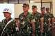 A military police person, left, escorts Indonesian service members, from left, Sami Lakka, Nandala Dwi Prasetya, Budhi Hariyanto Widhi Cahyono, and Edi Sudarko who are accused of carrying an acid attack to human right activist Andrie Yunus, on their arrival during their sentencing hearing at a military court in Jakarta, Indonesia, Wednesday, June 10, 2026.