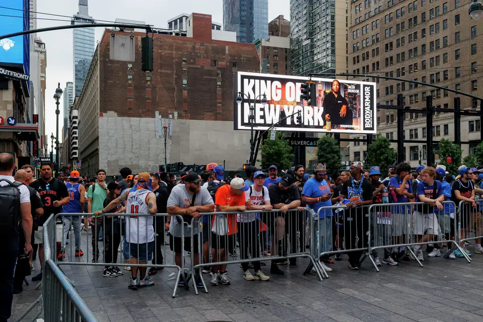 New York Knicks fans stand along the barricades put up by NYPD officers around Madison Square Garden in New York, Wednesday, June 10, 2026, ahead of Game 4 of the NBA Finals between the New York Knicks and the San Antonio Spurs.
