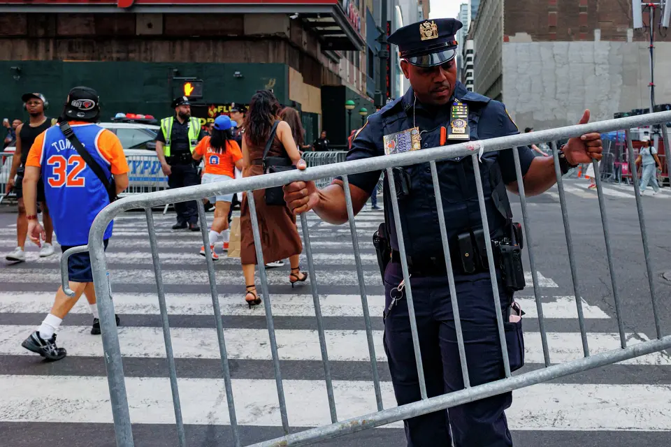 A New York police officer puts up barricades on the street around Madison Square Garden in New York, Wednesday, June 10, 2026, ahead of Game 4 of the NBA Finals between the New York Knicks and the San Antonio Spurs.