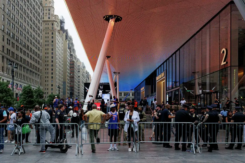 New York Knicks fans stand along the barricades put up by NYPD officers around Madison Square Garden in New York, Wednesday, June 10, 2026, ahead of Game 4 of the NBA Finals between the New York Knicks and the San Antonio Spurs.