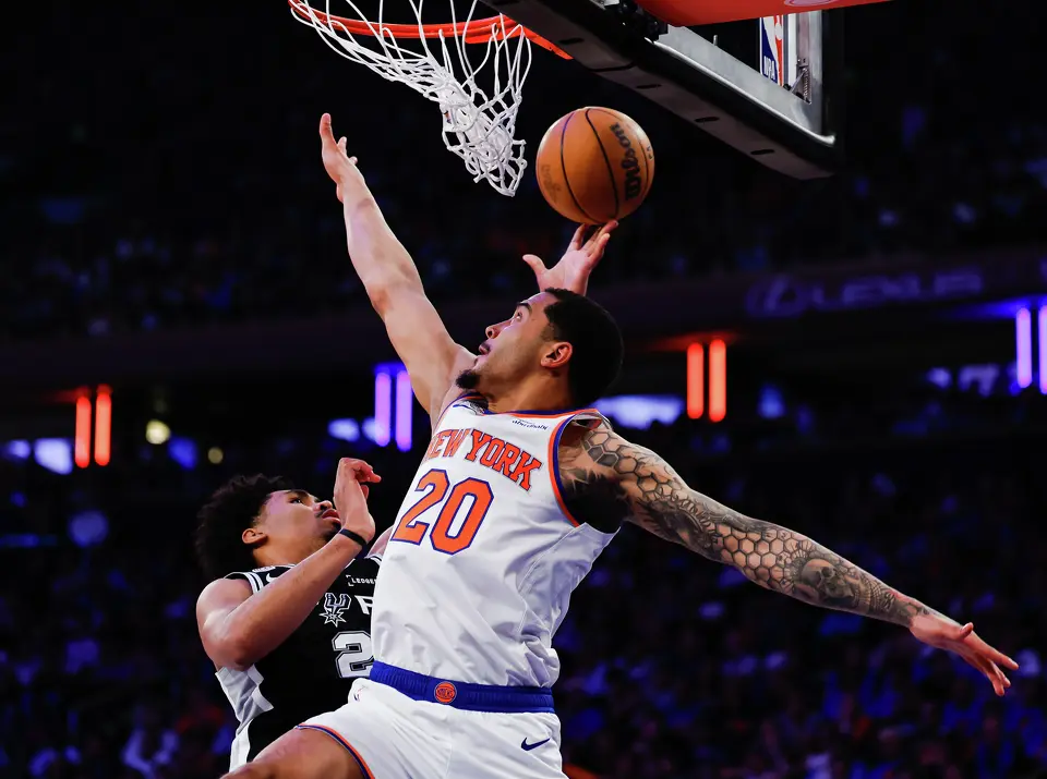 San Antonio Spurs guard Dylan Harper (2) and New York Knicks forward Jeremy Sochan (20) go up to the net during the second quarter of Game 4 of the NBA Finals at Madison Square Garden in New York, Wednesday, June 10, 2026.