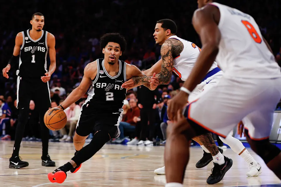 San Antonio Spurs guard Dylan Harper (2) dribbles around New York Knicks forward Jeremy Sochan (20) during the second quarter of Game 4 of the NBA Finals at Madison Square Garden in New York, Wednesday, June 10, 2026.