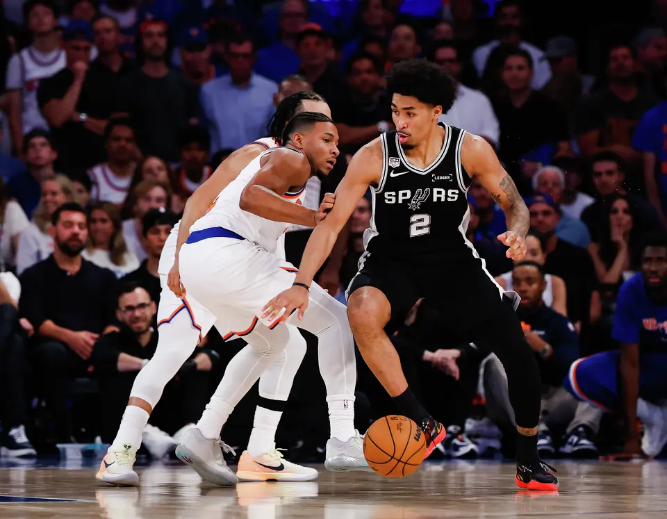 San Antonio Spurs guard Dylan Harper (2) dribbles the ball around New York Knicks guard Miles McBride (2) during the fourth quarter of Game 4 of the NBA Finals at Madison Square Garden in New York, Wednesday, June 10, 2026. The Knick defeated the Spurs 107-106, leading the series 3-1.