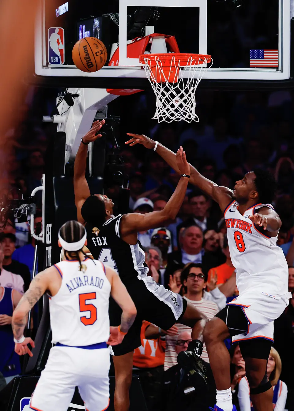San Antonio Spurs guard De'Aaron Fox (4) and New York Knicks forward Og Anunoby (8) go up to the basket during the fourth quarter of Game 4 of the NBA Finals at Madison Square Garden in New York, Wednesday, June 10, 2026. The Knicks defeated the Spurs 107-106, leading the series 3-1.