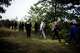 FILE - A Federal Police officer escorts a group of migrants who illegally crossed the border from Poland into Germany during a patrol in a forest near Forst, southeast of Berlin, Germany, on Oct. 11, 2023.