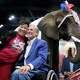 Aida Scott takes a photo with Governor Greg Abbott in front of an elephant named, Paige, during the Texas GOP convention in the George R. Brown Convention Center in Houston Friday, June 12, 2026. Paige is from the East Texas Elephant Experience in Cut and Shoot.