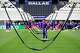 Members of the Japan men's national football team walk-beneath suspended a LED grass grow lighting system at Dallas Stadium in Arlington, June 13, 2026. Japan will face the Netherlands Sunday in the first of nine FIFA World Cup matches at the stadium.