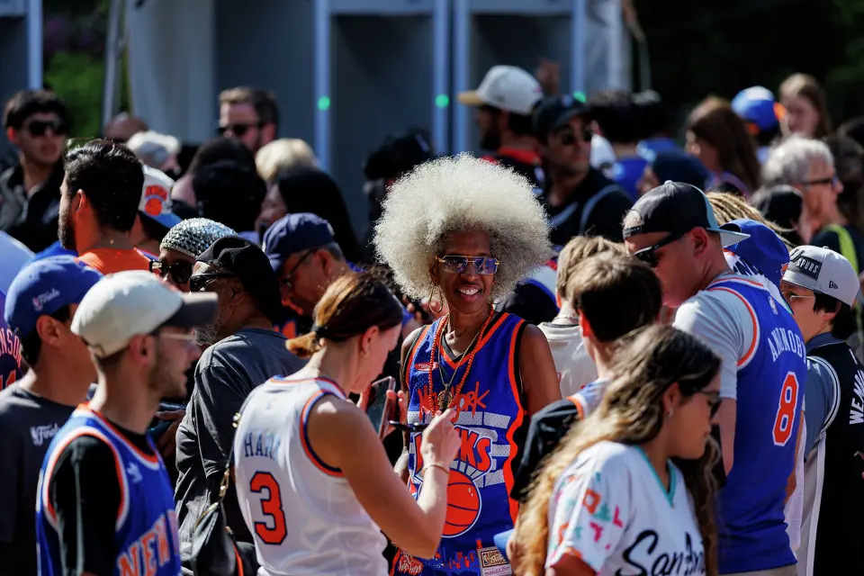 New York Knicks fan Erica Ford, center, stands stands in line to get into Frost Bank Center in San Antonio, Saturday, June 13, 2026, before Game 5 of the NBA Finals between the New York Knicks and the San Antonio Spurs.
