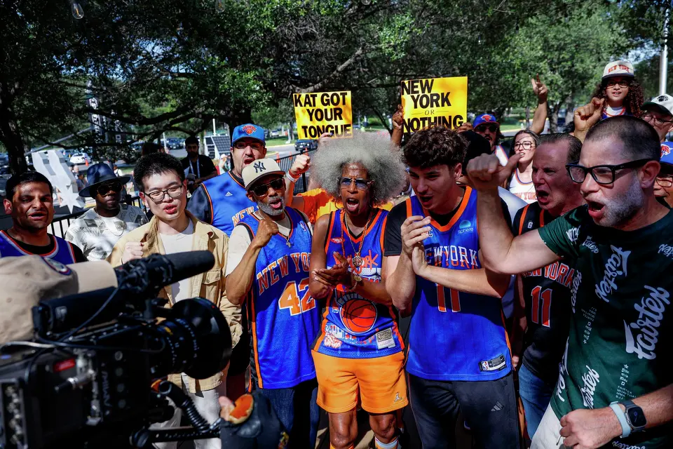 New York Knicks fans, including Erica Ford, center, chant “Go New York, Go New York, Go!” as they are filmed by a television station outside of Frost Bank Center in San Antonio, Saturday, June 13, 2026, before Game 5 of the NBA Finals between the Knicks and the San Antonio Spurs,