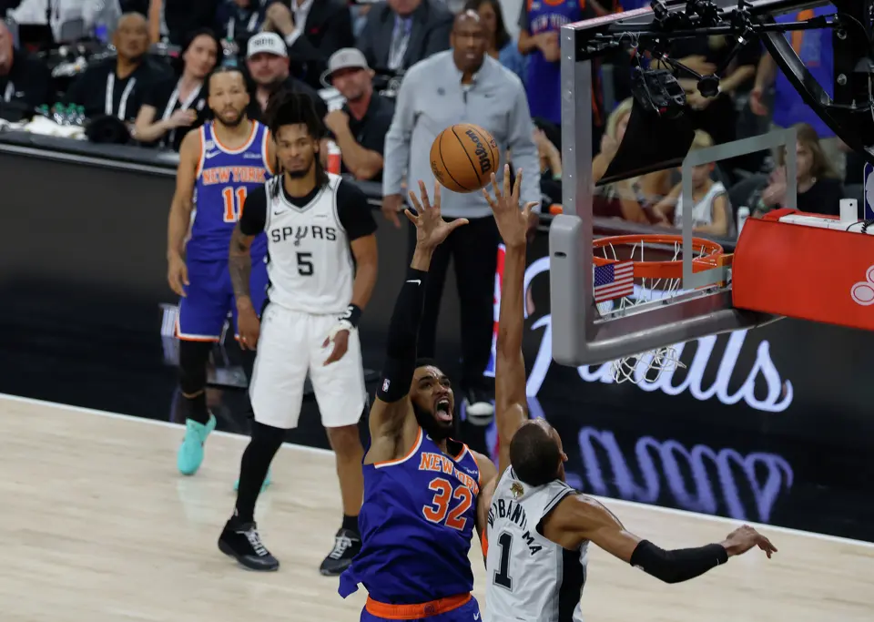 New York Knicks center Karl-Anthony Towns (32) tries to get a shot over San Antonio Spurs center Victor Wembanyama (1) during the first quarter of game five of the NBA Championship at Frost Bank Center on Saturday, June13, 2026.