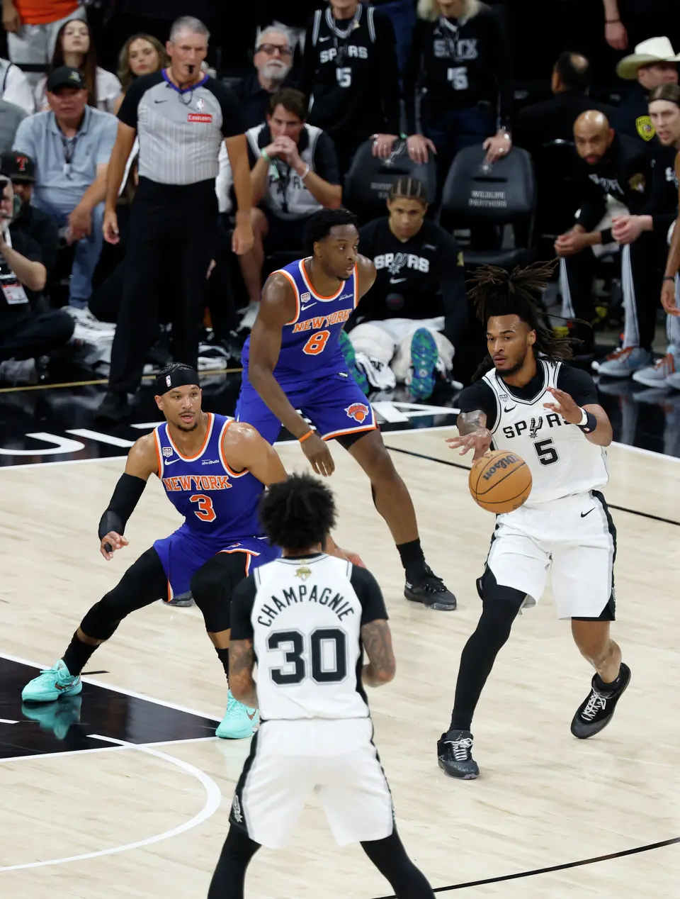 San Antonio Spurs guard Stephon Castle (5) passes the ball off to San Antonio Spurs forward Julian Champagnie (30) during the first quarter of game five of the NBA Championship at Frost Bank Center on Saturday, June13, 2026.