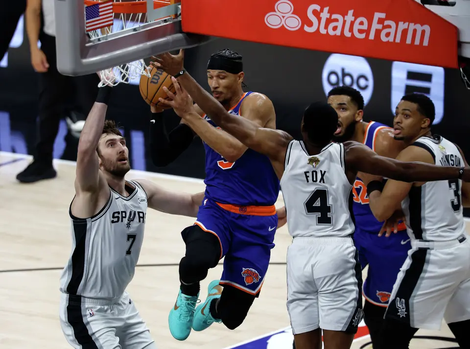 New York Knicks guard Josh Hart (3) goes for a layup past San Antonio Spurs center Luke Kornet (7) and San Antonio Spurs guard De'Aaron Fox (4) during the first quarter of game five of the NBA Championship at Frost Bank Center on Saturday, June13, 2026.