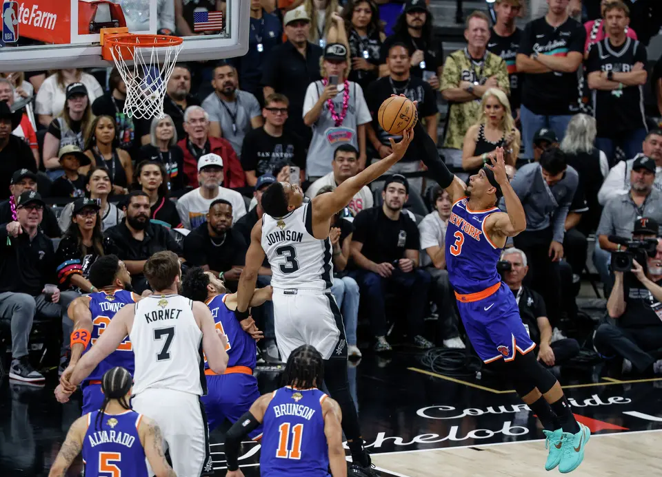 San Antonio Spurs forward Keldon Johnson (3) and New York Knicks guard Josh Hart (3) battle for a rebound during the first quarter of game five of the NBA Championship at Frost Bank Center on Saturday, June13, 2026.