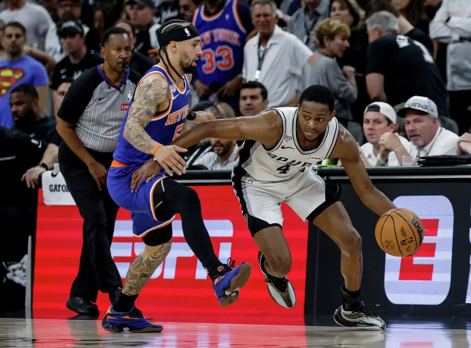 San Antonio Spurs guard De'Aaron Fox (4) drives up the court past New York Knicks guard Jose Alvarado (5) during the second quarter of game five of the NBA Championship at Frost Bank Center on Saturday, June13, 2026.